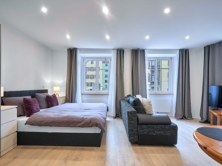 seeglueck | Münsterzauber | zentral 9 Helles Doppelbett unter zwei Fenstern im Appartement Münsterzauber